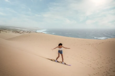 Sandboarding on the dunes at Tamri