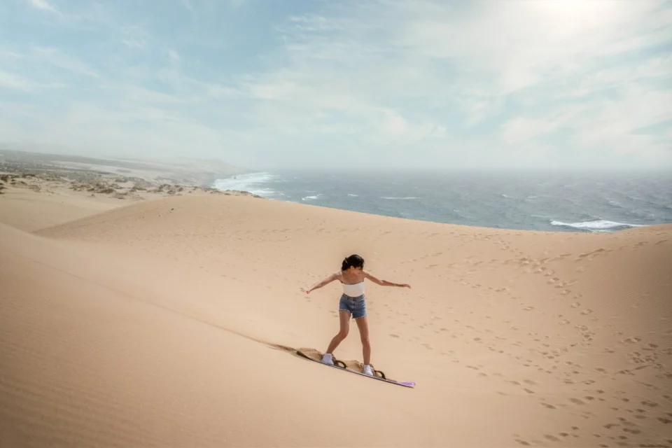 Sandboarding on the dunes at Tamri
